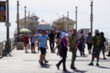 © jdoms - blur background of people walking on ocean pier