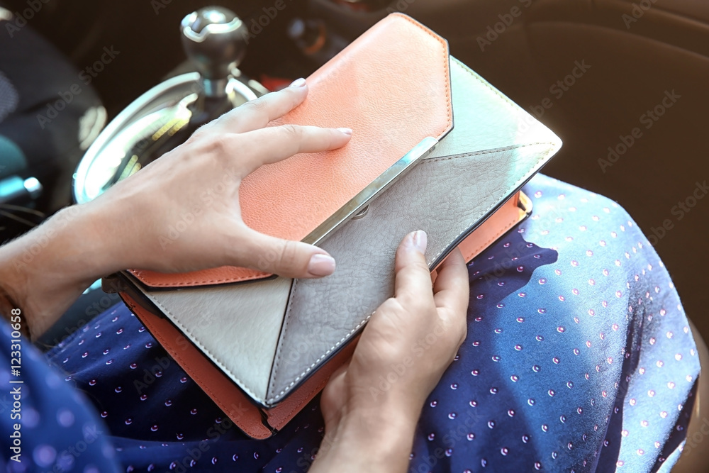 Girl with bag in car
