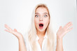 Shocked amazed young woman standing and shouting