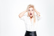 © Drobot Dean - Young blonde businesswoman shouting and covering her ears with hands
