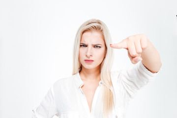 Canvas Print - Young serious beautiful businesswoman pointing at camera