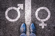 Legs with male female gender symbols on asphalt, gender identity choice, queer and transgender concept