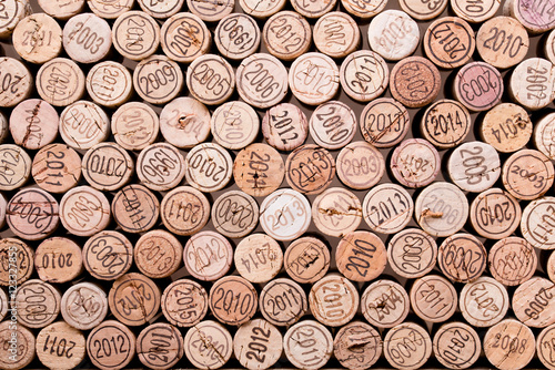 Naklejka dekoracyjna stacking wine cork background with vintage years