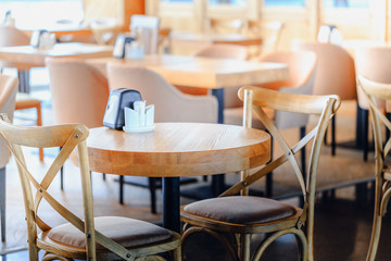 Restaurant roomy hall with wooden furniture. Nobody scene.