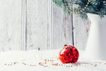 Composition with Christmas decorations in vase on wooden background