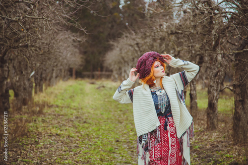Fotografia, Obraz Young girl in extravagant style of ethnic grunge standing in autumn park