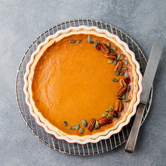 Wall Mural - Pumpkin pie, tart in a baking dish. Top view