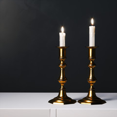 Wall Mural - Coper candelabras with candles on the white surface. 3d render