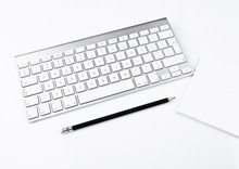 White Office Computer Keyboard With Black Pencil