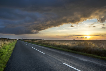 Road to Kennack with stormy looking sunset, Lizard peninsula, Cornwall, UK