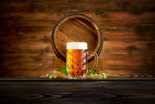 Pint Of Cold Beer And Old Barrel On Wooden Background
