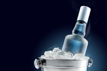 Bottle Of Cold Vodka In Bucket Of Ice On Dark Background