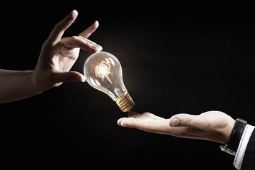 Wall Mural - hand pointing light bulb . mixed media