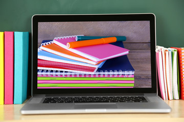 Wall Mural - Laptop with stationery wallpaper on screen, closeup. School teacher concept.