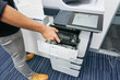 Businessman put ink cartridge into printer