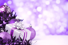 Purple Christmas Scene With Baubles And Gift