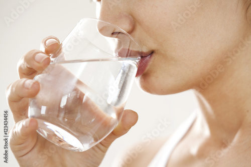 Plakat Młoda kobieta pije szkło woda