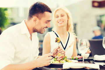 Poster - happy couple eating dinner at restaurant terrace