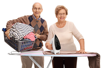 Canvas Print - Cheerful senior couple ironing together