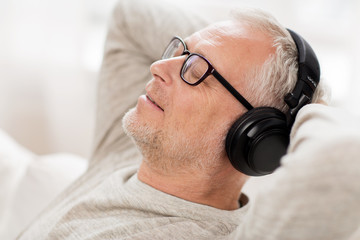 Poster - happy man in headphones listening to music at home