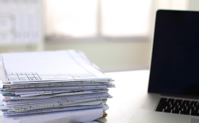 office desk a stack of computer paper reports work forms