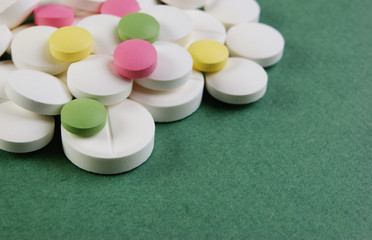 Wall Mural - Pills and tablets on a green background