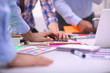 © lenetsnikolai - Close-up of three young creative designers working on project together. Team work
