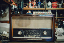 A Table With An Old Vintage Radio In Cafe.