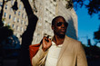 © instax - Young Black Businessman Walking on the Streets of Manhattan . New York City