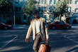 © instax - Young Black Businessman Walking on the Streets of Manhattan . New York City
