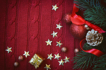 Wall Mural - Christmas red knitted background with golden stars