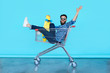 © kegfire - handsome young hipster man sitting in the shopping cart