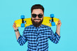 © kegfire - hipster man holding a bright vibrant yellow skateboard
