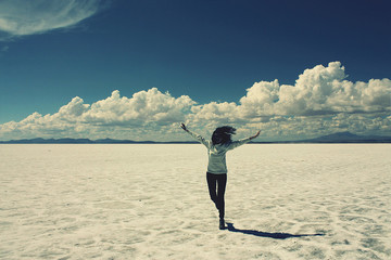 caucasian skinny woman staring, salar de uyuni salt lake, bolivi