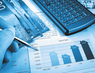 Fototapete - Male hand with pen on the investment chart with calculator and canadian dollars