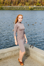 Redhead Young Woman Walking In Autumn Park Near Water