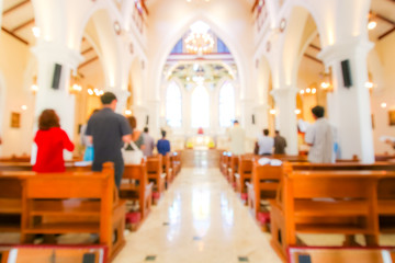 blurred christian mass praying inside the church