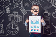 © kanashkin - Little boy as a businessman with mustache and glasses shows graph of the company's business activities on dark background  pattern