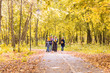 © satura_ - walking family with three children in autumnal park