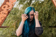 © ADDICTIVE STOCK - Teen blue hair girl next to the bridge beam.
