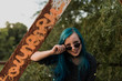 © ADDICTIVE STOCK - Cheering teen blue hair girl next to the bridge beam.