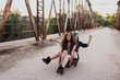 © ADDICTIVE STOCK - Two teens sit on one skateboard and laughing