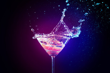 Wall Mural - Colorful cocktail with splash on lights background