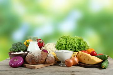 Fototapete - Vegetables and dairy products on blurred background