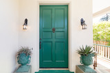 Green entry door with door knock.