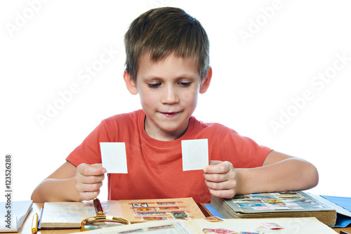 Cuadros en Lienzo Boy with his collection of old postage stamps isolated