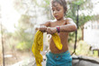 © Westend61 - Boy standing on trampoline wringing out his wet t-shirt