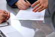 © rogerphoto - Business people discussing contract. Close up of male hand pointing to the paper
