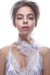 © iulskaya_photo - Beautiful girl in image of bride with flower orchid on her neck. Model with nude makeup and silk underwear. Beauty face. Photo was taken in a studio.