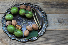 Fresh Walnuts In A Green Shell, A Vintage Wooden Background

